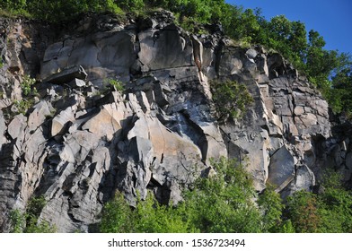 Tree-coverd Sunny Whinstone Cliff In The Summer Afternoon