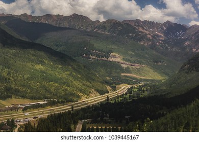 Tree-covered Vail Mountain With Blue Skies And Shadows Cast From The Clouds Above On A Summer Day In Vail, Colorado