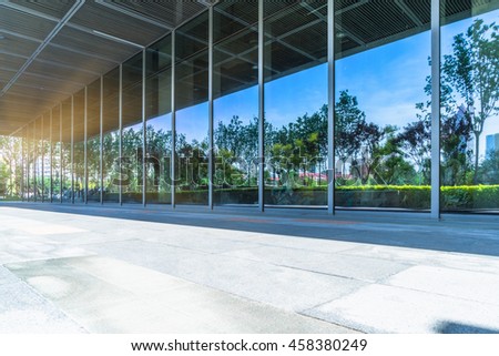 trees and blue sky reflected on clean glass wall,china.
