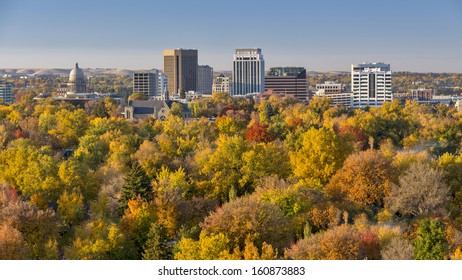 Trees in full autumn color and the skyline of Boise Idaho