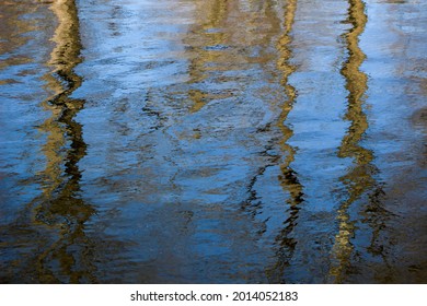 Trees reflected in the water creating a textured paint look.