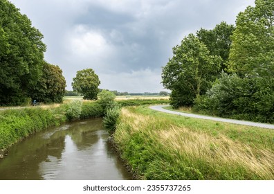 Trees reflecting in the bending River Demer, Langdorp, Flanders, Belgium