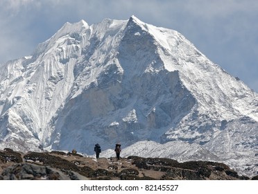 Trekkers against of snow-covered Island peak (6189 m)  - Nepal, Himalayas