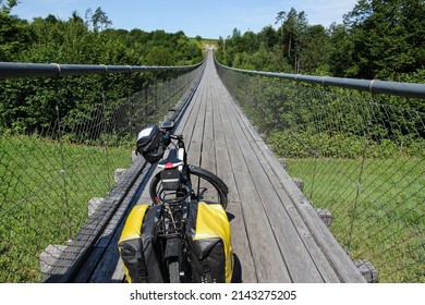 Trekking Bike With Saddle Bags On Suspension Bridge