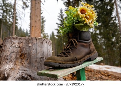 Trekking Boot With Flowers Showing The Way