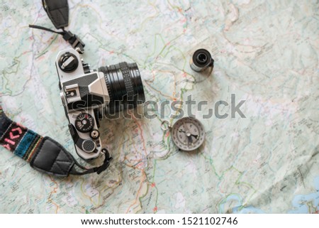trekking map with analogic analog camera and compass, for travellers and explorer photographers of beatiful places on route and vacaction