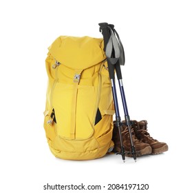 Trekking poles, backpack and boots on white background