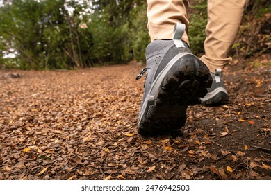 Trekking shoes in closeup. Girl walking through fall forest. - Powered by Shutterstock