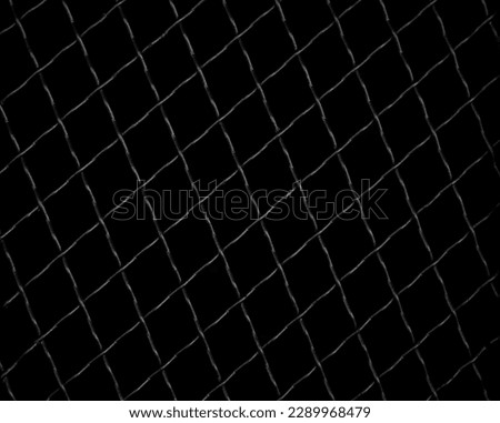Trellised window. Metal lattices with rhombus pattern. Close-up image. isolated on black background.  Window with Wrought Iron Security Bars. 