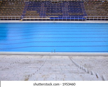 Trembling Surface Of An Olympic Size Swimming Pool In Empty Sport Arena