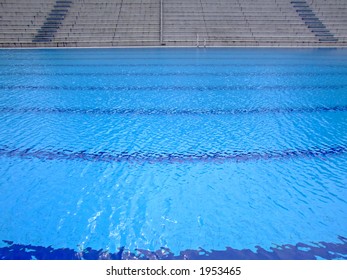 Trembling Surface Of An Olympic Size Swimming Pool In Empty Sport Arena