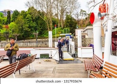 Tremezzo, Italy - 15 April 2018 - Unidentified Tourists Step Away From And Aboard To While The Ferry Stopping At Villa Carlotta Port (Scalo Di Villa Carlotta).