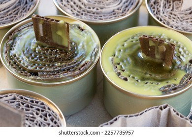 A trench candle is the name of a device for obtaining light, heating, drying clothes and cooking food in the form of a can, in which cardboard filled with wax or paraffin is placed. - Shutterstock ID 2257735957