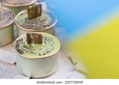 A trench candle is the name of a device for obtaining light, heating, drying clothes and cooking food in the form of a can, in which cardboard filled with wax or paraffin is placed. - Shutterstock ID 2257735959