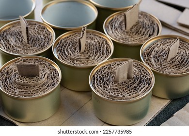 A trench candle is the name of a device for obtaining light, heating, drying clothes and cooking food in the form of a can, in which cardboard filled with wax or paraffin is placed. - Shutterstock ID 2257735985