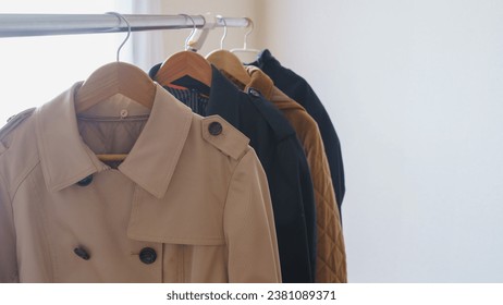 Trench coat hanging on a hanger.