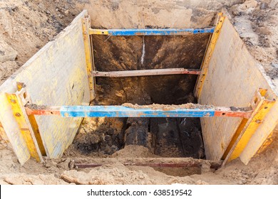 Trench To Repair The Pipe Break. Walls Reinforced With Metal Supports To Prevent Sloughing Of The Soil.