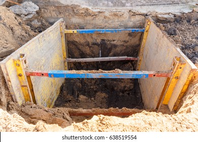 Trench To Repair The Pipe Break. Walls Reinforced With Metal Supports To Prevent Sloughing Of The Soil.