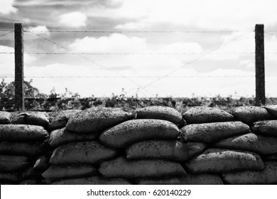 Trenches with barbed wire and blue sky with white clouds