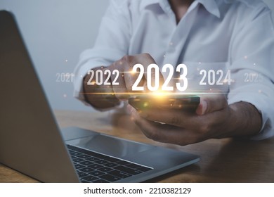 Trend of 2023. people business investor using mobile phone with virtual 2023 year diagram, business trend, change from 2022 to 2023, strategy, investment, business planning and happy new year concept