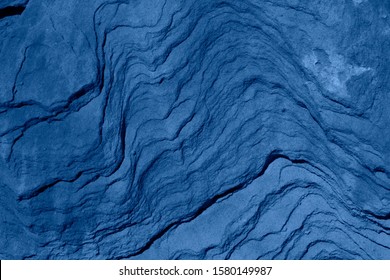 Trend color 2020 classic blue, top view, layout for design. Mountain texture in trendy blue color. Trendy color concept of the year, classic blue background. Modern stylish, top view, copy space.