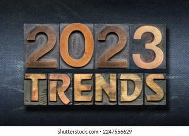 trends 2023 phrase made from wooden letterpress on dark jeans background - Shutterstock ID 2247556629