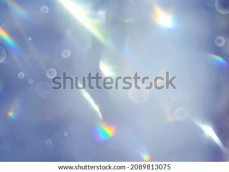 Trendy abstract Very Peri colour background with rainbow flares, bokeh orbs, and light leaks