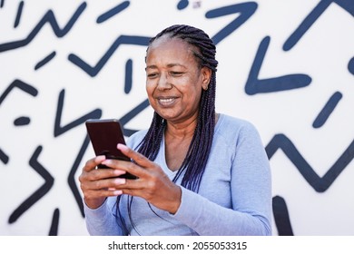 Trendy African American Senior Woman Using Mobile Phone In The City With Black And White Background - Elderly Black Lady Enjoy Technology