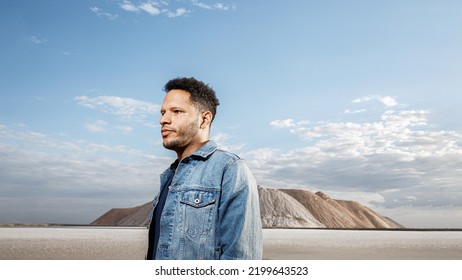 Trendy African Black Man Against The Backdrop Of Mountains In Stylish Classic Jean Jacket With Fashionable Hairstyle Handsome Man Model Portrait Fashion Concept Mens Clothing