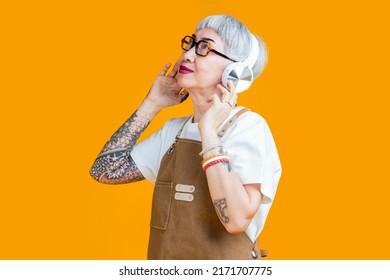 Trendy Asian Senior Old Woman Female Wear Headphone Listening Music Melody While Wear Apron Hand Touch Earphone Casual Relax Lifestyle,easy Listening Music Asia Woman With Tattoo Close Eye Feel Free