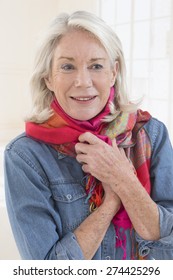 Trendy attractive senior woman with wearing a stylish scarf