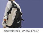 Trendy Backpack with Cute Plush Keychain in purple template background 