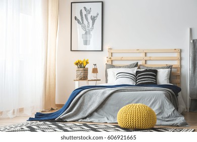 Trendy Bedroom Interior With King-size Bed, Pouf, Flowers And Cactus Poster