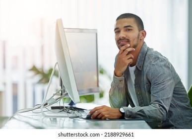 Trendy businessman, IT or software engineer with good innovation and web development design development idea at tech company. Face portrait of a young ux or ui designer with a modern desktop - Shutterstock ID 2188929661