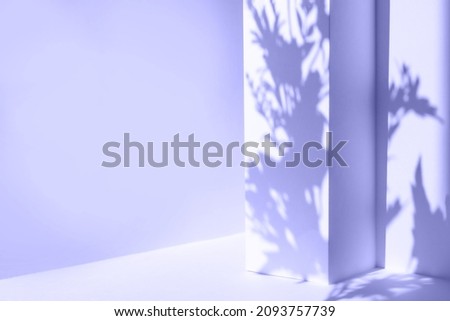 Trendy Color of the Year 2022 very peri. Empty purple table and geometric wall background with flowers and palm leaves shadows overlay. Abstract studio, product presentation, 3d room, copy space.