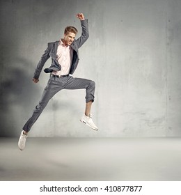 Trendy elegant guy jumping in air
