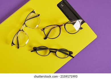 Trendy Eye Glasses On A Purple And Yellow Background Glasses For Study, Computer Work And Reading, Fashionable Eyeglass Frames