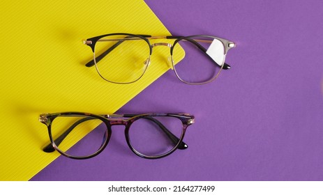 Trendy Eye Glasses On A Purple And Yellow Background Glasses For Study, Computer Work And Reading, Fashionable Eyeglass Frames