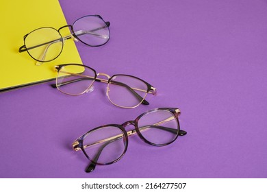 Trendy Eye Glasses On A Purple And Yellow Background Glasses For Study, Computer Work And Reading, Fashionable Eyeglass Frames