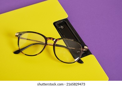 Trendy Eye Glasses On A Purple And Yellow Background Glasses For Study, Computer Work And Reading, Fashionable Eyeglass Frames