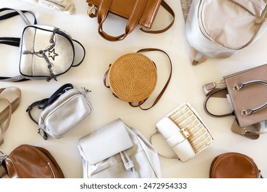 Trendy fashionable women's bags in neutral beige colors. White background. Fashion and beauty concept. Top view. Copy space.