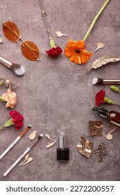 Trendy feminine set with make up brushes accessories, dropper bottles, sunglasses, cosmetics and gerbera flowers with copy space in the centre. - Shutterstock ID 2272200557
