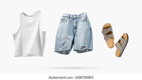 Trendy flying cotton tank top, blue jeans shorts, vegan cork sandals isolated on gray background. Clean white crop top. Branding clothes. Mock up for your design. Spring Summer Women's Clothing.