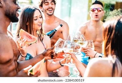 Trendy friends group drinking white wine champagne at private pool side party - Life style vacation concept with young men and women having fun together on summer day at luxury resort - Bright filter - Powered by Shutterstock