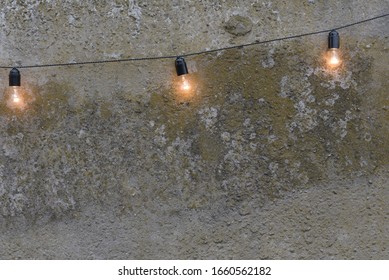 Trendy Globe String Lights Outdoor In Private Garden With Fence. Light Bulbs On The Fence