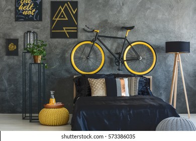 Trendy Grey Bedroom With Bed, Bike And Wall Posters