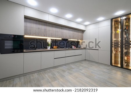 Trendy grey modern kitchen interior with minimalistic furniture