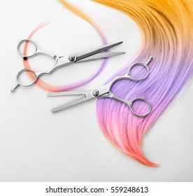 Trendy hairstyle concept  Colorful dyed hair   scissors white background