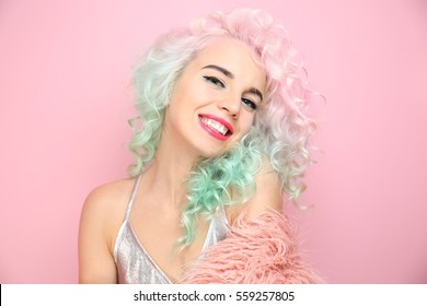 Trendy hairstyle concept  Young woman and colorful dyed hair pink background