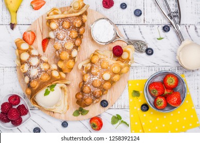 Trendy Hong Kong Bubble Waffles Ready For Stuffing With Ingredients On White Wooden Background. Copy Space